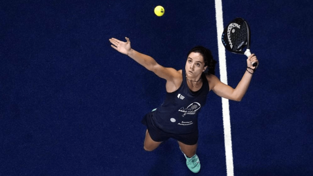 Padel player preparing to strike an overhead ball